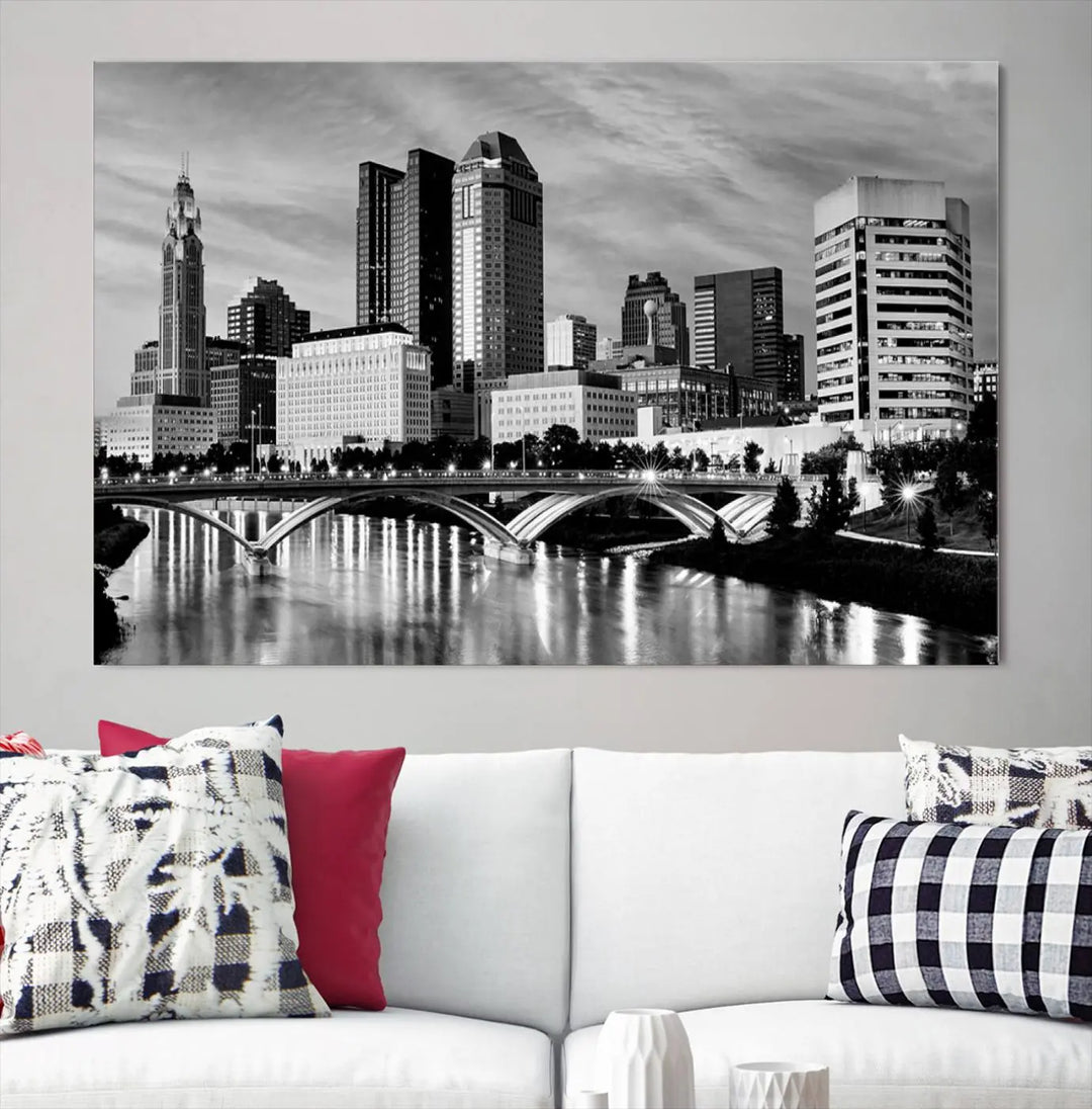 Columbus City Lights Skyline Black and White Wall Art Cityscape Canvas Print, featuring a city skyline over a river, is elegantly displayed.