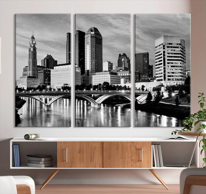 Columbus City Lights Skyline Black and White Wall Art Cityscape Canvas Print, featuring a city skyline over a river, is elegantly displayed.