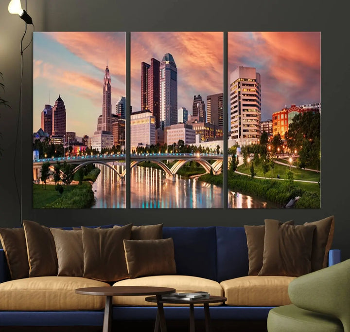 The "Columbus City Lights Sunset Orange Cloudy Skyline Cityscape View Wall Art Canvas Print" showcases a vibrant city skyline at sunset with a bridge spanning a river, strikingly displayed on museum-quality canvas.