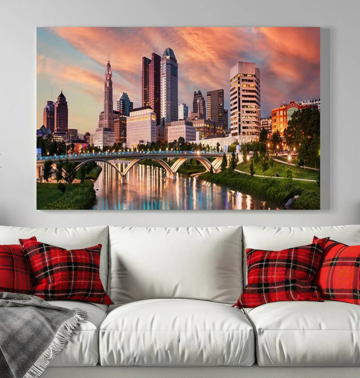 The "Columbus City Lights Sunset Orange Cloudy Skyline Cityscape View Wall Art Canvas Print" showcases a vibrant city skyline at sunset with a bridge spanning a river, strikingly displayed on museum-quality canvas.