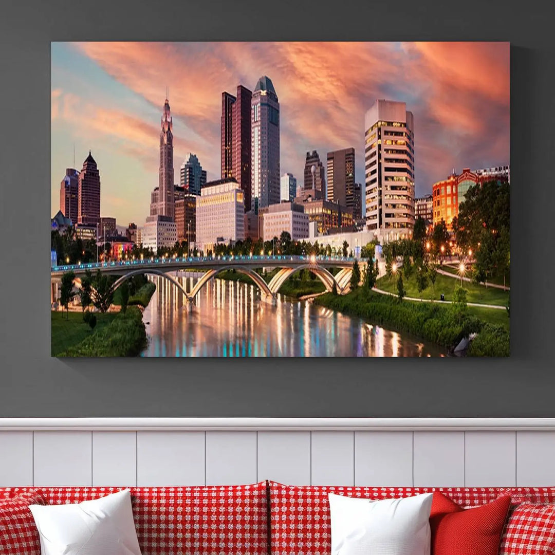 The "Columbus City Lights Sunset Orange Cloudy Skyline Cityscape View Wall Art Canvas Print" showcases a vibrant city skyline at sunset with a bridge spanning a river, strikingly displayed on museum-quality canvas.