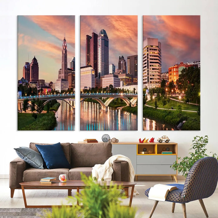 The "Columbus City Lights Sunset Orange Cloudy Skyline Cityscape View Wall Art Canvas Print" showcases a vibrant city skyline at sunset with a bridge spanning a river, strikingly displayed on museum-quality canvas.