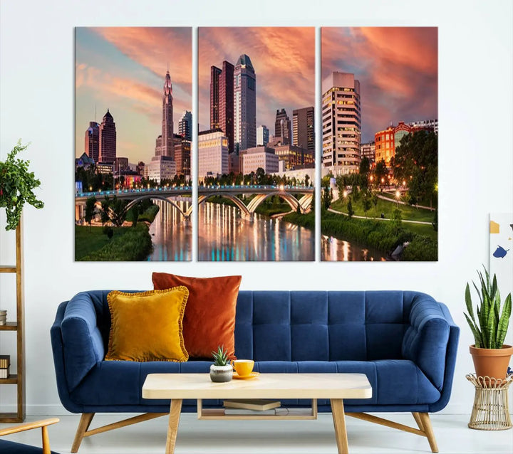 The "Columbus City Lights Sunset Orange Cloudy Skyline Cityscape View Wall Art Canvas Print" showcases a vibrant city skyline at sunset with a bridge spanning a river, strikingly displayed on museum-quality canvas.