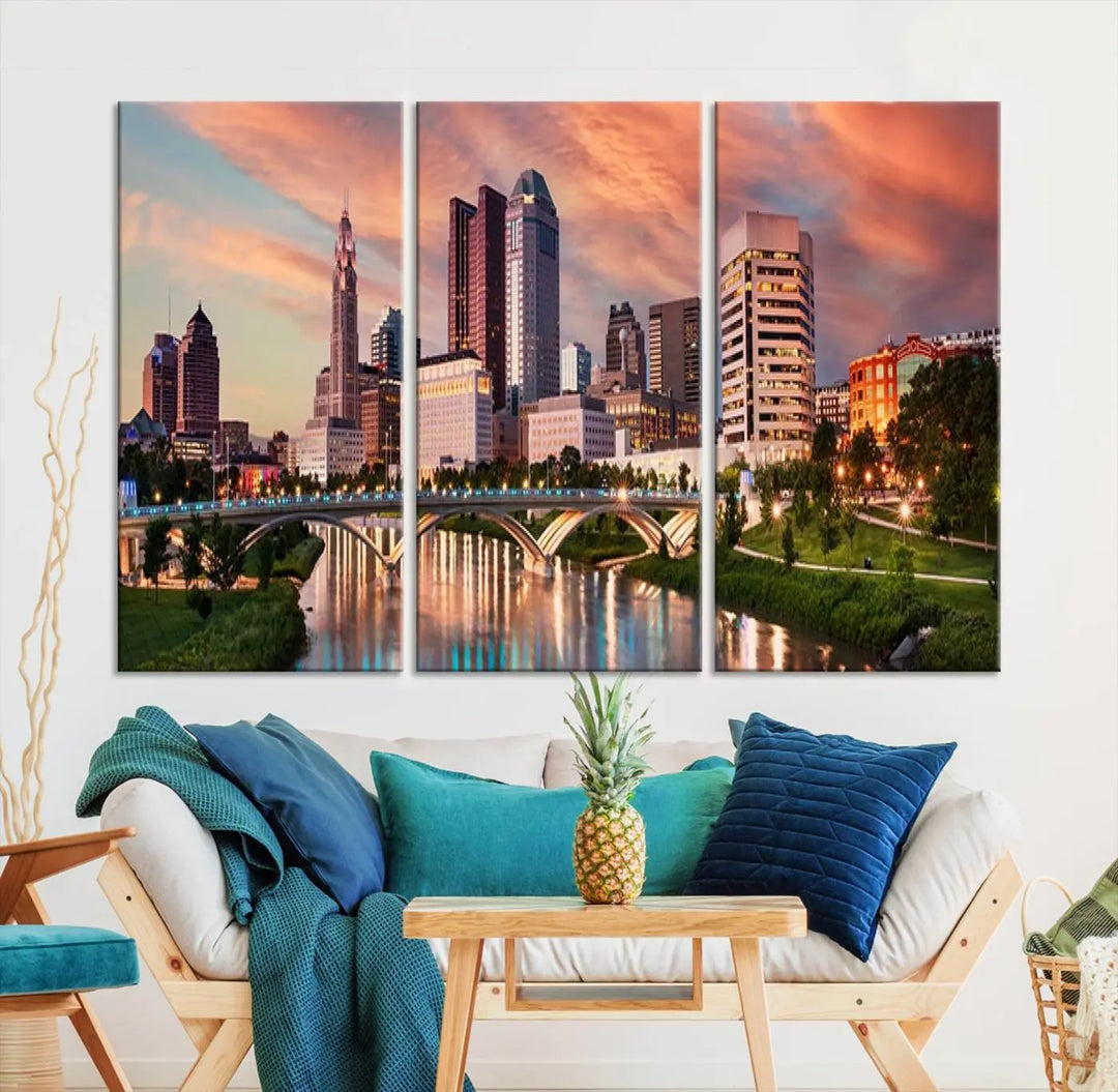 The "Columbus City Lights Sunset Orange Cloudy Skyline Cityscape View Wall Art Canvas Print" showcases a vibrant city skyline at sunset with a bridge spanning a river, strikingly displayed on museum-quality canvas.