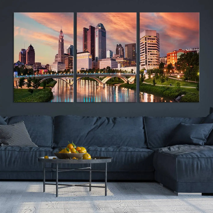 The "Columbus City Lights Sunset Orange Cloudy Skyline Cityscape View Wall Art Canvas Print" showcases a vibrant city skyline at sunset with a bridge spanning a river, strikingly displayed on museum-quality canvas.