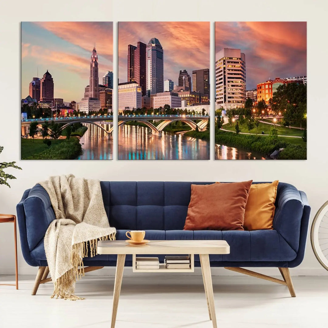 The "Columbus City Lights Sunset Orange Cloudy Skyline Cityscape View Wall Art Canvas Print" showcases a vibrant city skyline at sunset with a bridge spanning a river, strikingly displayed on museum-quality canvas.