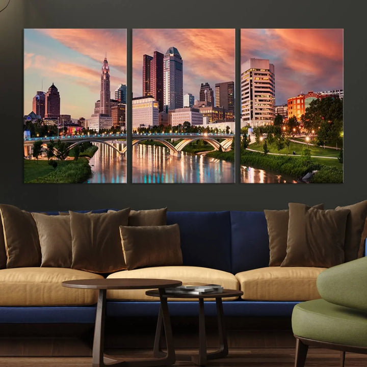 The "Columbus City Lights Sunset Orange Cloudy Skyline Cityscape View Wall Art Canvas Print" showcases a vibrant city skyline at sunset with a bridge spanning a river, strikingly displayed on museum-quality canvas.