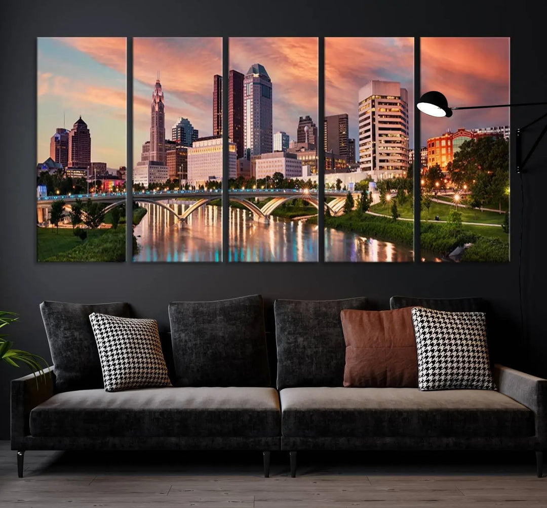 The "Columbus City Lights Sunset Orange Cloudy Skyline Cityscape View Wall Art Canvas Print" showcases a vibrant city skyline at sunset with a bridge spanning a river, strikingly displayed on museum-quality canvas.