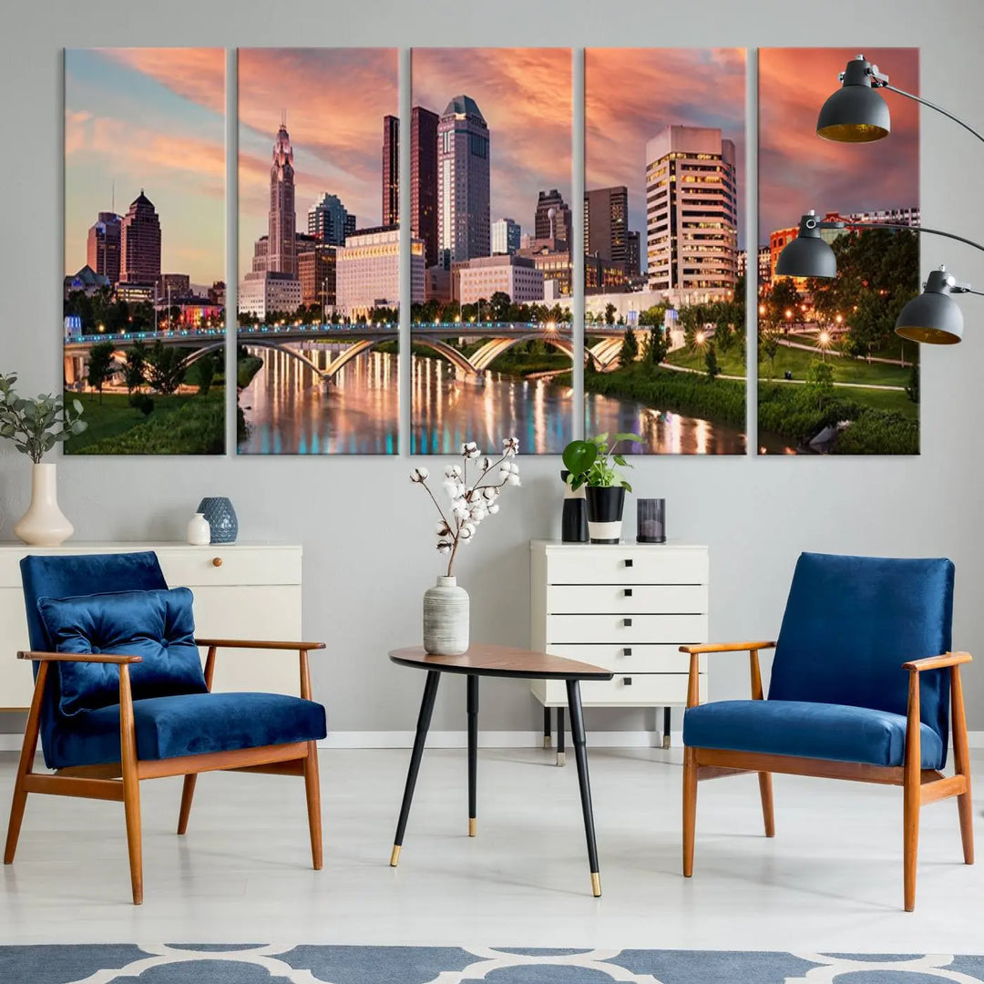 The "Columbus City Lights Sunset Orange Cloudy Skyline Cityscape View Wall Art Canvas Print" showcases a vibrant city skyline at sunset with a bridge spanning a river, strikingly displayed on museum-quality canvas.