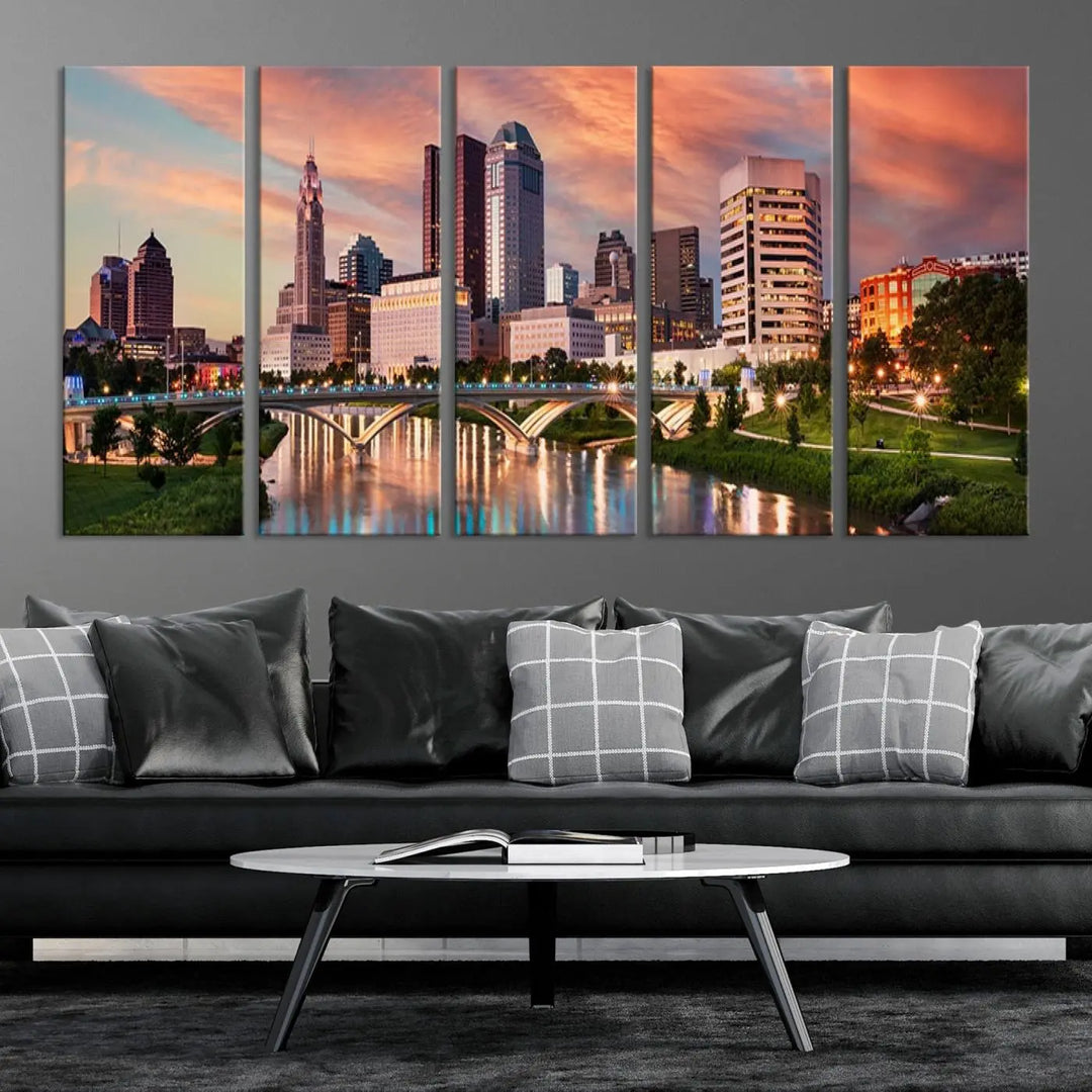 The "Columbus City Lights Sunset Orange Cloudy Skyline Cityscape View Wall Art Canvas Print" showcases a vibrant city skyline at sunset with a bridge spanning a river, strikingly displayed on museum-quality canvas.