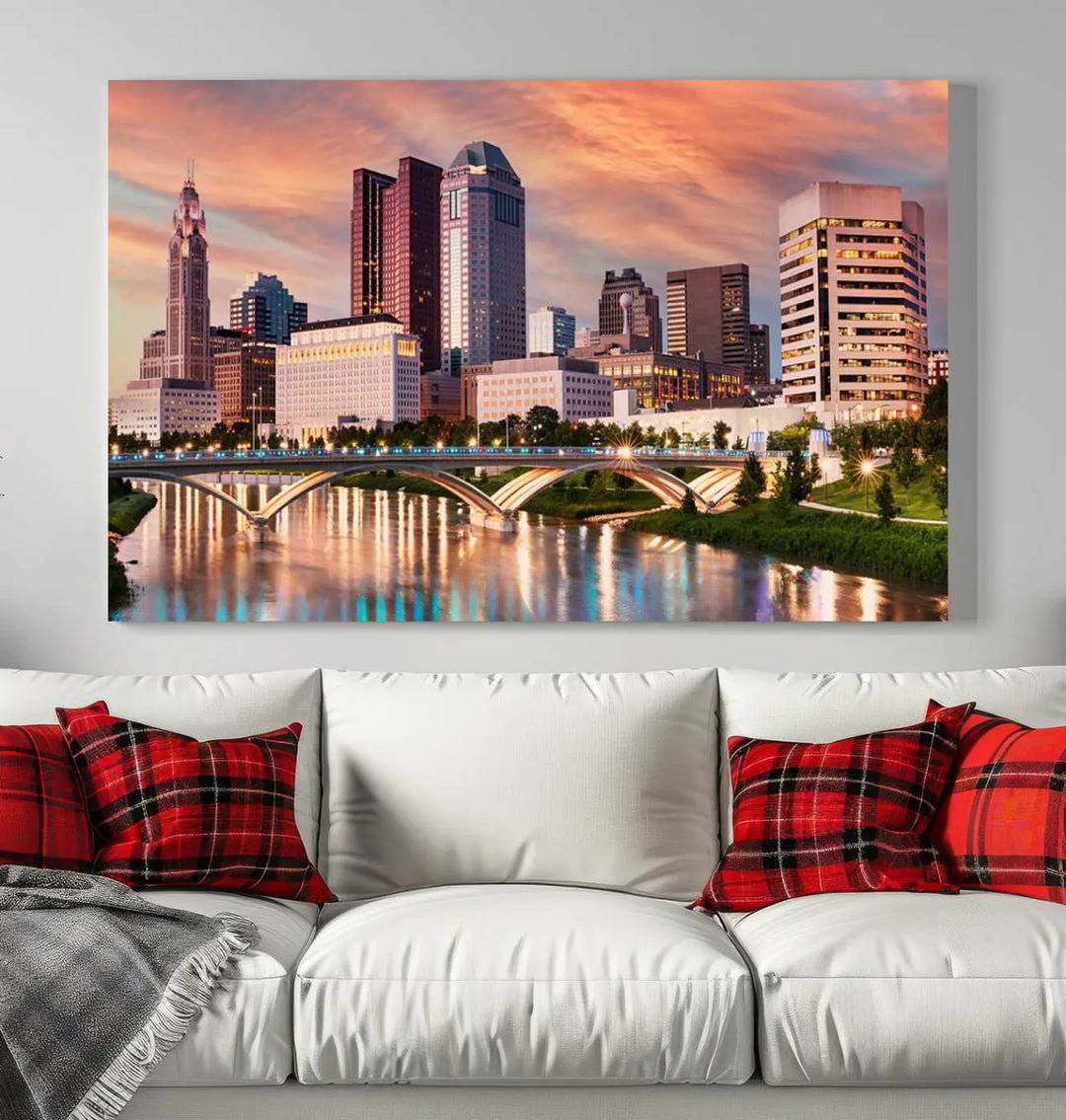 The "Columbus City Lights Sunset Orange Cloudy Skyline Cityscape View" wall art is featured on the wall. This triptych is printed on museum-quality canvas and includes a UV-protective coating, ensuring lasting vibrancy.