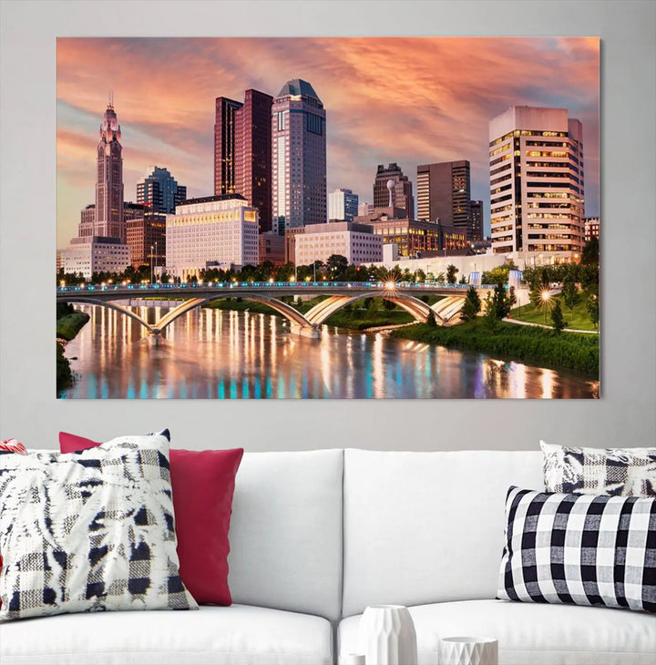 The "Columbus City Lights Sunset Orange Cloudy Skyline Cityscape View" wall art is featured on the wall. This triptych is printed on museum-quality canvas and includes a UV-protective coating, ensuring lasting vibrancy.