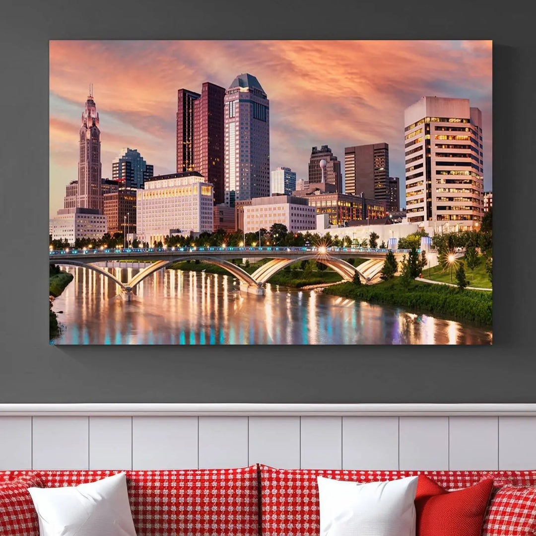 The "Columbus City Lights Sunset Orange Cloudy Skyline Cityscape View" wall art is featured on the wall. This triptych is printed on museum-quality canvas and includes a UV-protective coating, ensuring lasting vibrancy.