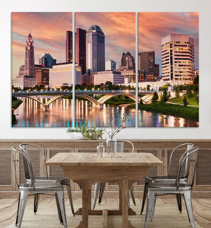 The "Columbus City Lights Sunset Orange Cloudy Skyline Cityscape View" wall art is featured on the wall. This triptych is printed on museum-quality canvas and includes a UV-protective coating, ensuring lasting vibrancy.