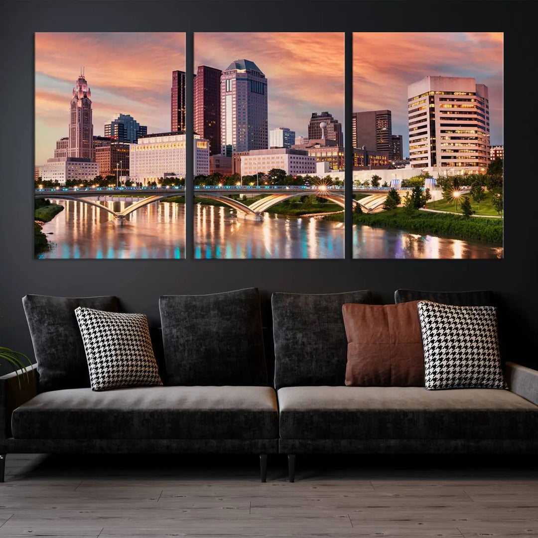 The "Columbus City Lights Sunset Orange Cloudy Skyline Cityscape View" wall art is featured on the wall. This triptych is printed on museum-quality canvas and includes a UV-protective coating, ensuring lasting vibrancy.