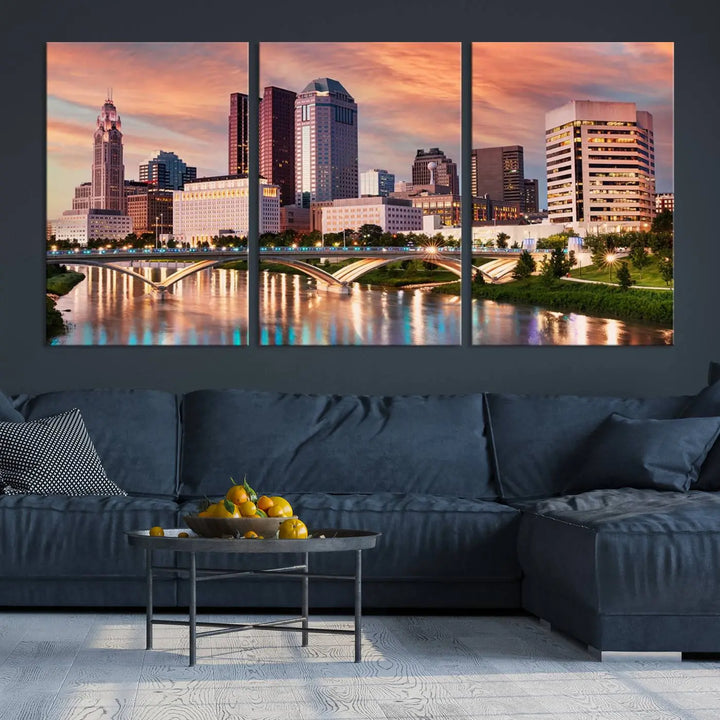 The "Columbus City Lights Sunset Orange Cloudy Skyline Cityscape View" wall art is featured on the wall. This triptych is printed on museum-quality canvas and includes a UV-protective coating, ensuring lasting vibrancy.