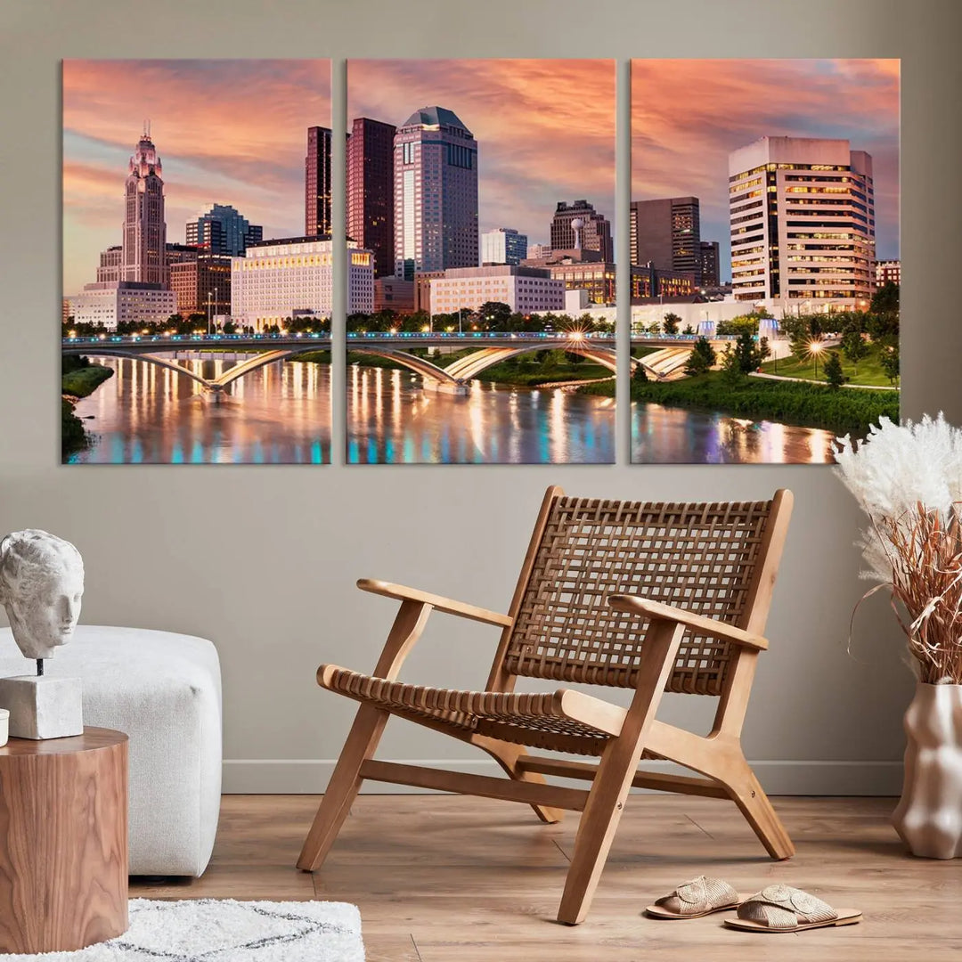 The "Columbus City Lights Sunset Orange Cloudy Skyline Cityscape View" wall art is featured on the wall. This triptych is printed on museum-quality canvas and includes a UV-protective coating, ensuring lasting vibrancy.