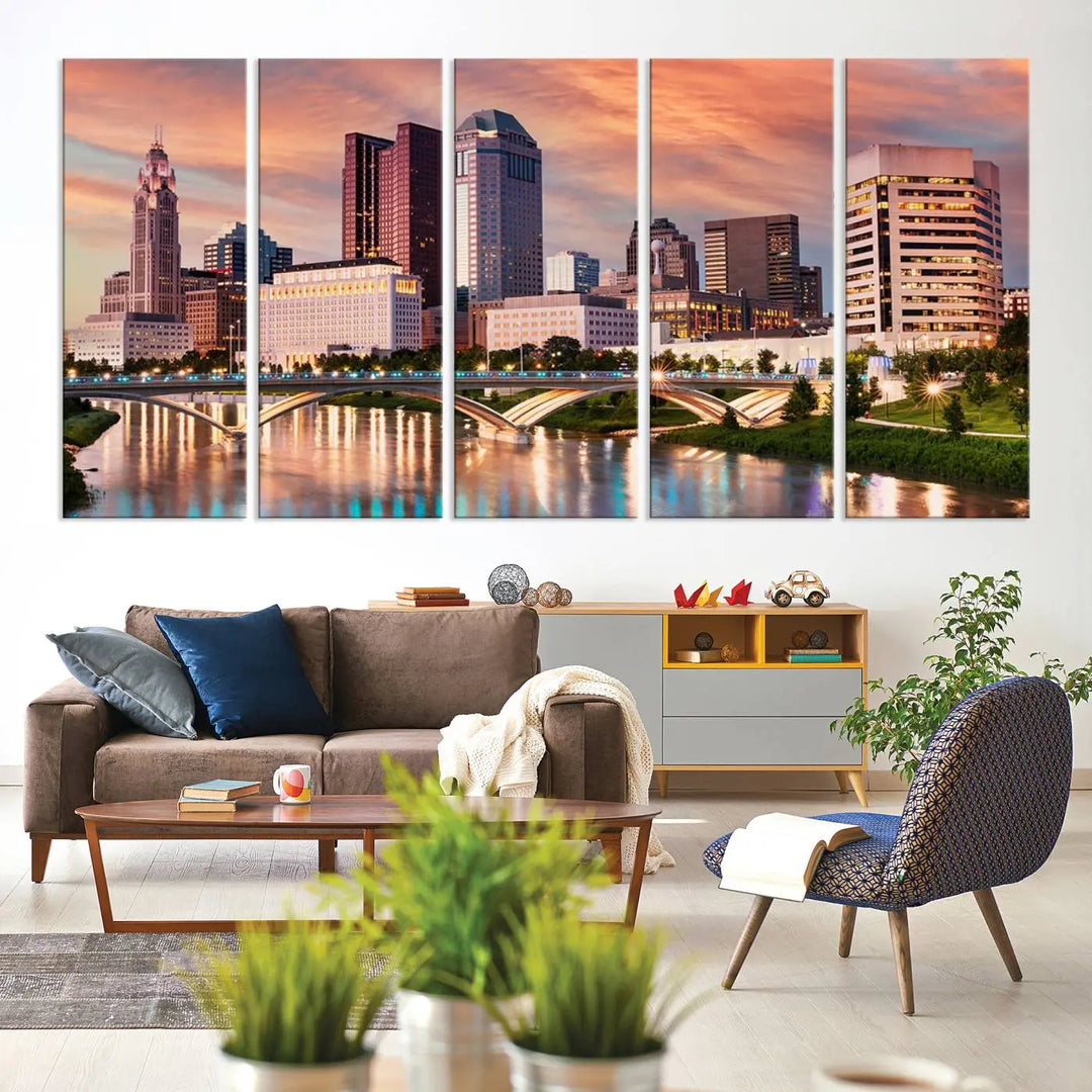 The "Columbus City Lights Sunset Orange Cloudy Skyline Cityscape View" wall art is featured on the wall. This triptych is printed on museum-quality canvas and includes a UV-protective coating, ensuring lasting vibrancy.