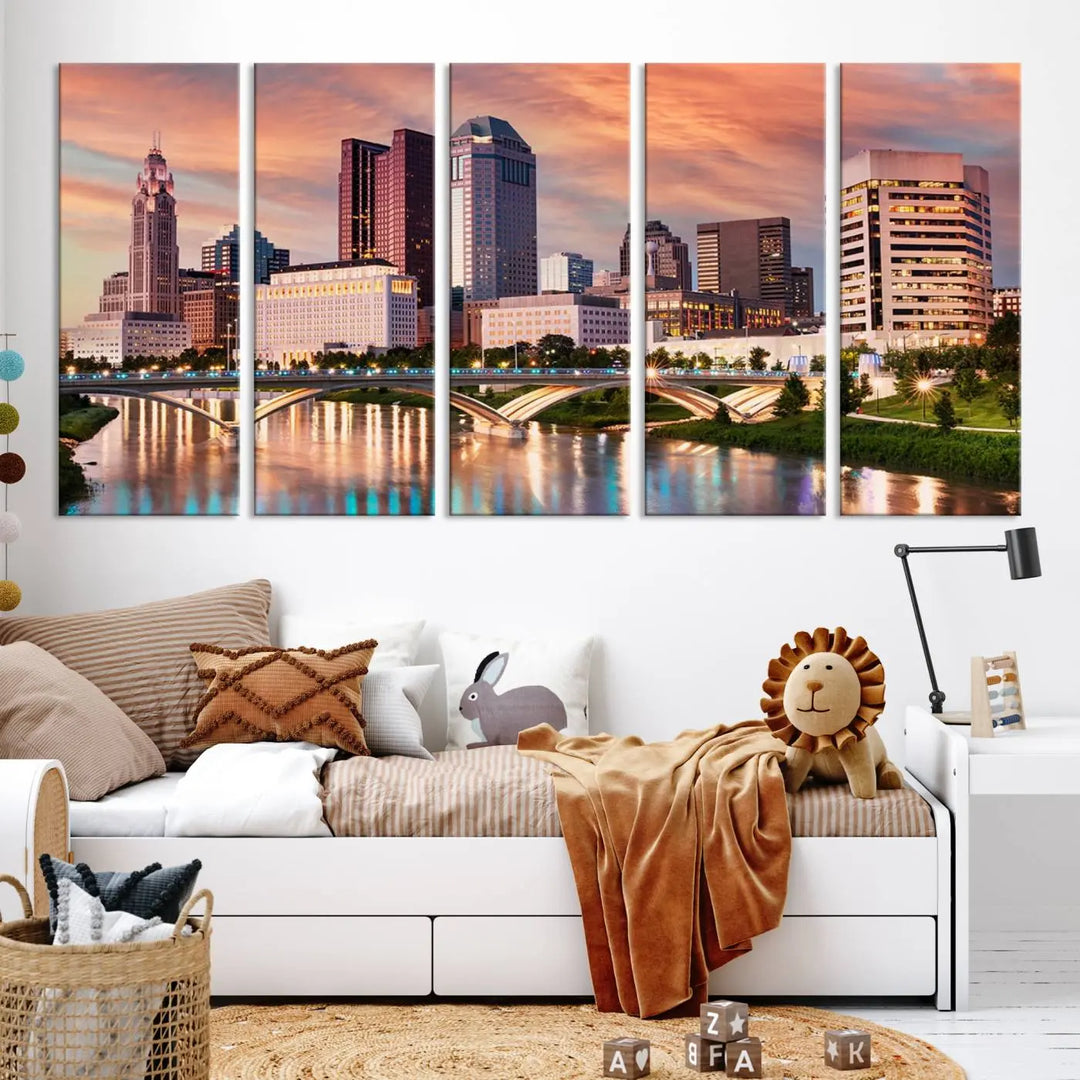 The "Columbus City Lights Sunset Orange Cloudy Skyline Cityscape View" wall art is featured on the wall. This triptych is printed on museum-quality canvas and includes a UV-protective coating, ensuring lasting vibrancy.