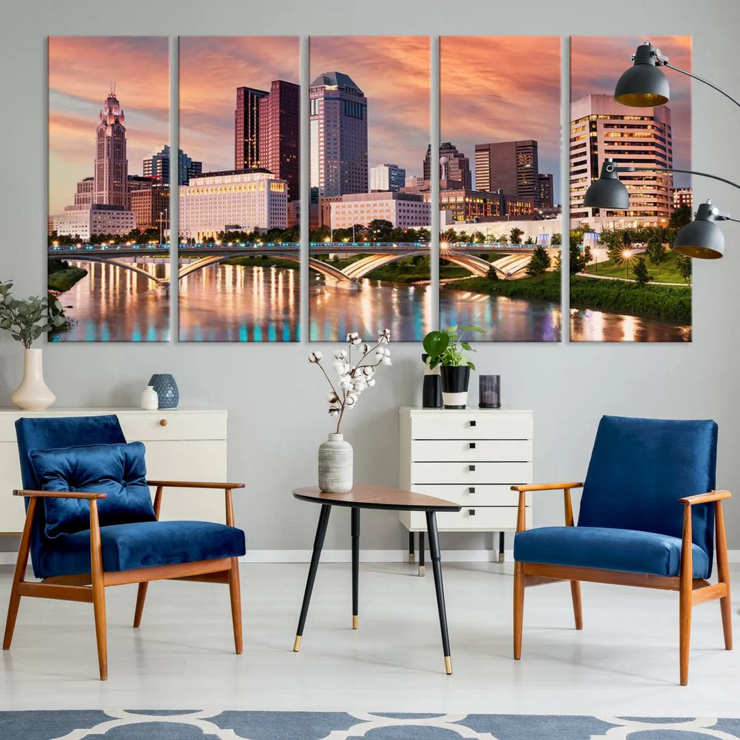 The "Columbus City Lights Sunset Orange Cloudy Skyline Cityscape View" wall art is featured on the wall. This triptych is printed on museum-quality canvas and includes a UV-protective coating, ensuring lasting vibrancy.