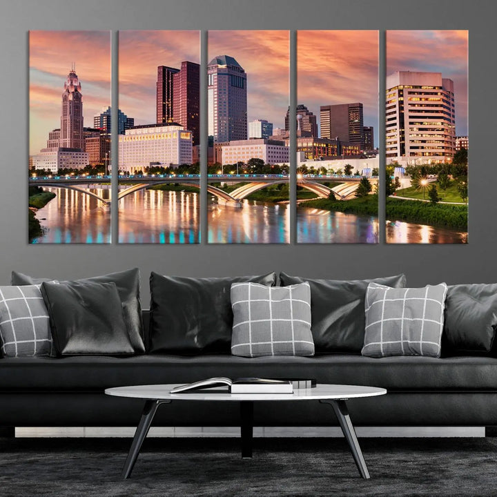 The "Columbus City Lights Sunset Orange Cloudy Skyline Cityscape View" wall art is featured on the wall. This triptych is printed on museum-quality canvas and includes a UV-protective coating, ensuring lasting vibrancy.