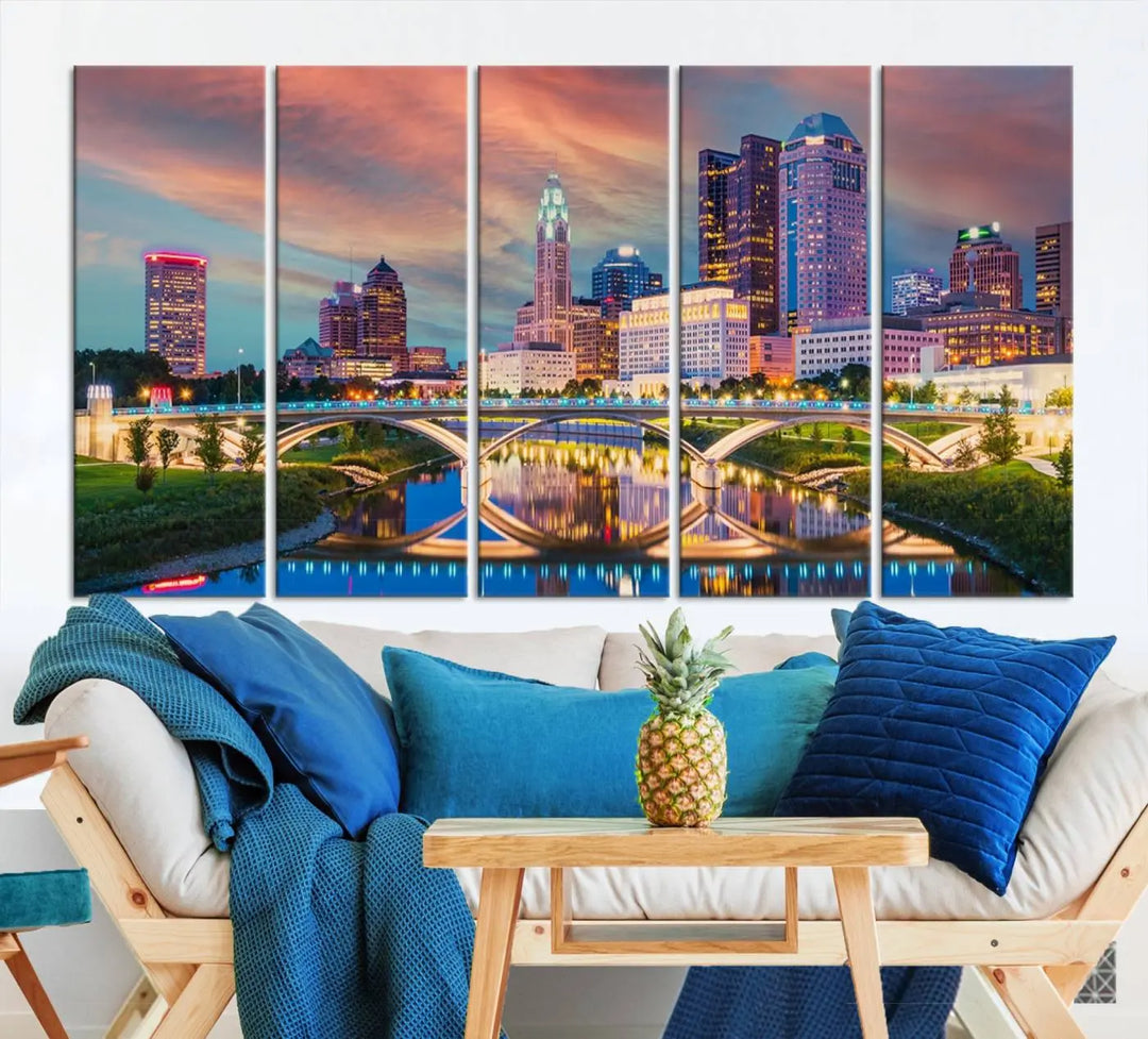 The living room features the Columbus City Lights Sunset Orange Cloudy Skyline Cityscape View Wall Art Canvas Print, designed to be museum-quality and ready to hang under warm lighting.