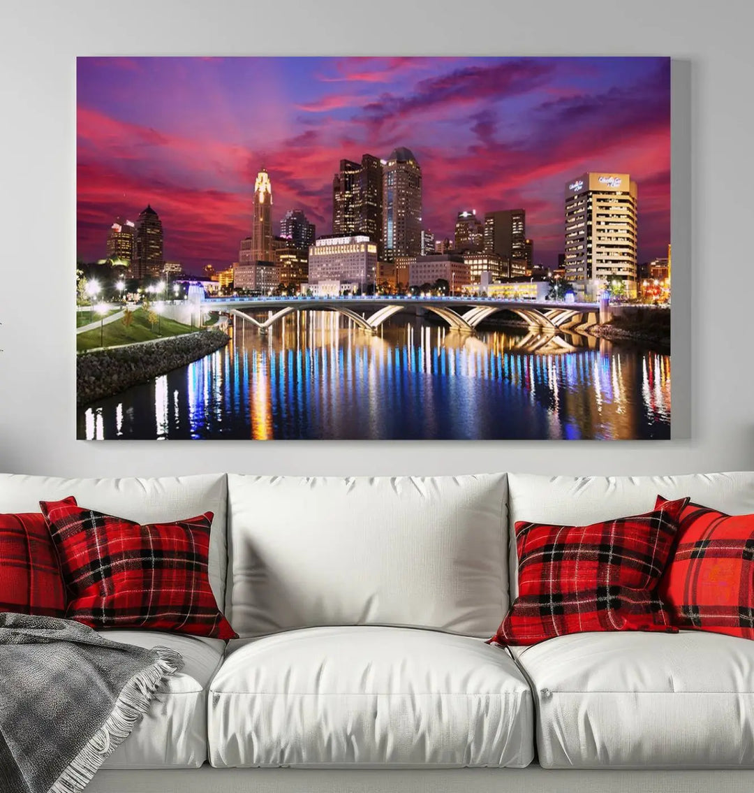 The "Columbus City Lights Sunset Pink and Purple Cloudy Skyline Cityscape View Wall Art Canvas Print" captures the beauty of a city skyline at dusk with its reflection on the river. Crafted on museum-quality canvas with a UV-protective coating, this triptych wall art is ready to hang and adds an elegant touch to any room.