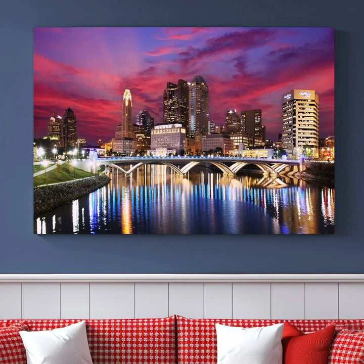 The "Columbus City Lights Sunset Pink and Purple Cloudy Skyline Cityscape View Wall Art Canvas Print" captures the beauty of a city skyline at dusk with its reflection on the river. Crafted on museum-quality canvas with a UV-protective coating, this triptych wall art is ready to hang and adds an elegant touch to any room.