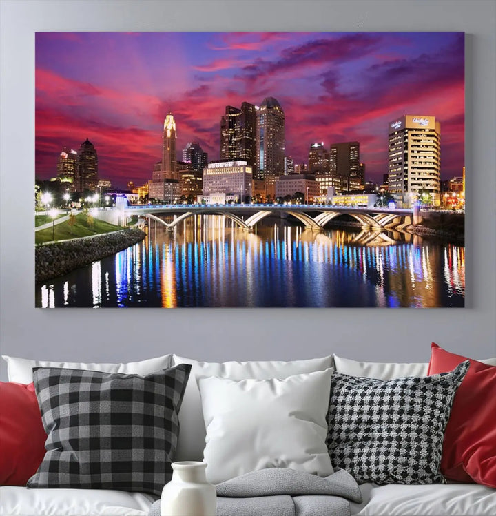 The "Columbus City Lights Sunset Pink and Purple Cloudy Skyline Cityscape View Wall Art Canvas Print" captures the beauty of a city skyline at dusk with its reflection on the river. Crafted on museum-quality canvas with a UV-protective coating, this triptych wall art is ready to hang and adds an elegant touch to any room.