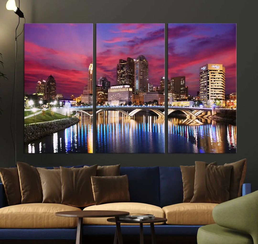 The "Columbus City Lights Sunset Pink and Purple Cloudy Skyline Cityscape View Wall Art Canvas Print" captures the beauty of a city skyline at dusk with its reflection on the river. Crafted on museum-quality canvas with a UV-protective coating, this triptych wall art is ready to hang and adds an elegant touch to any room.