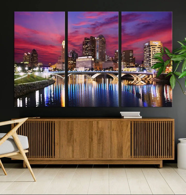 The "Columbus City Lights Sunset Pink and Purple Cloudy Skyline Cityscape View Wall Art Canvas Print" captures the beauty of a city skyline at dusk with its reflection on the river. Crafted on museum-quality canvas with a UV-protective coating, this triptych wall art is ready to hang and adds an elegant touch to any room.