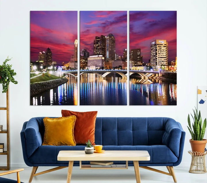 The "Columbus City Lights Sunset Pink and Purple Cloudy Skyline Cityscape View Wall Art Canvas Print" captures the beauty of a city skyline at dusk with its reflection on the river. Crafted on museum-quality canvas with a UV-protective coating, this triptych wall art is ready to hang and adds an elegant touch to any room.