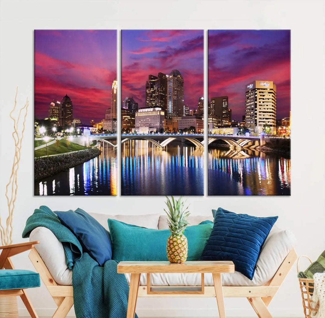 The "Columbus City Lights Sunset Pink and Purple Cloudy Skyline Cityscape View Wall Art Canvas Print" captures the beauty of a city skyline at dusk with its reflection on the river. Crafted on museum-quality canvas with a UV-protective coating, this triptych wall art is ready to hang and adds an elegant touch to any room.