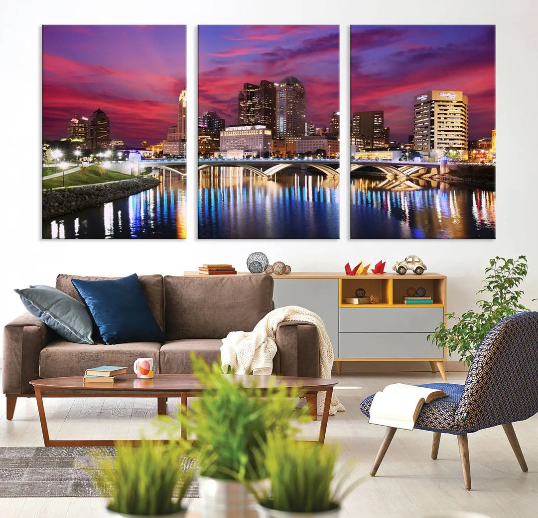 The "Columbus City Lights Sunset Pink and Purple Cloudy Skyline Cityscape View Wall Art Canvas Print" captures the beauty of a city skyline at dusk with its reflection on the river. Crafted on museum-quality canvas with a UV-protective coating, this triptych wall art is ready to hang and adds an elegant touch to any room.