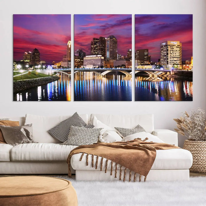 The "Columbus City Lights Sunset Pink and Purple Cloudy Skyline Cityscape View Wall Art Canvas Print" captures the beauty of a city skyline at dusk with its reflection on the river. Crafted on museum-quality canvas with a UV-protective coating, this triptych wall art is ready to hang and adds an elegant touch to any room.