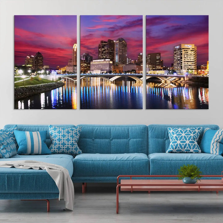 The "Columbus City Lights Sunset Pink and Purple Cloudy Skyline Cityscape View Wall Art Canvas Print" captures the beauty of a city skyline at dusk with its reflection on the river. Crafted on museum-quality canvas with a UV-protective coating, this triptych wall art is ready to hang and adds an elegant touch to any room.