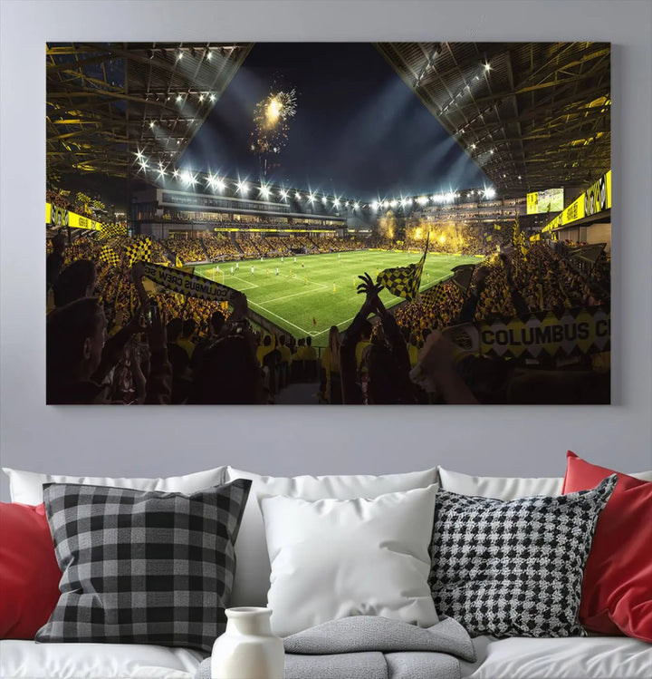 The wall of a modern living room is adorned with a triptych canvas titled "Columbus Crew Soccer Team Print," capturing the vibrant energy of the Columbus Crew Stadium in high-resolution printing.