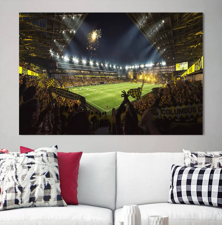 The wall of a modern living room is adorned with a triptych canvas titled "Columbus Crew Soccer Team Print," capturing the vibrant energy of the Columbus Crew Stadium in high-resolution printing.