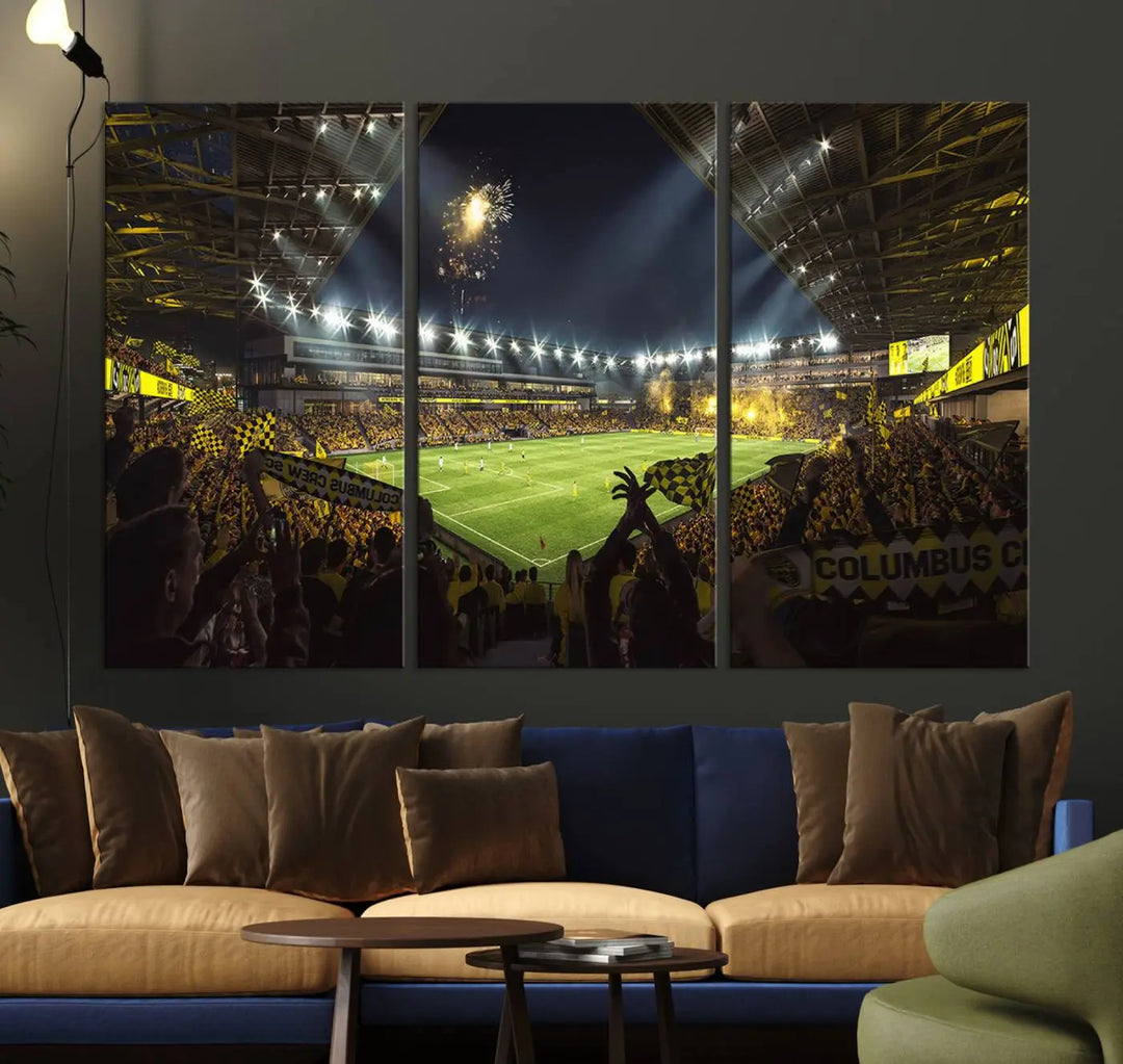 The wall of a modern living room is adorned with a triptych canvas titled "Columbus Crew Soccer Team Print," capturing the vibrant energy of the Columbus Crew Stadium in high-resolution printing.