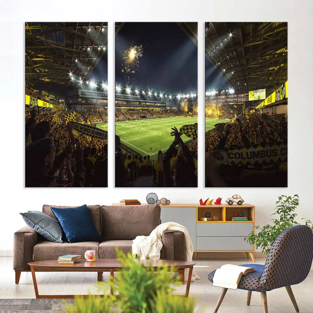 The wall of a modern living room is adorned with a triptych canvas titled "Columbus Crew Soccer Team Print," capturing the vibrant energy of the Columbus Crew Stadium in high-resolution printing.