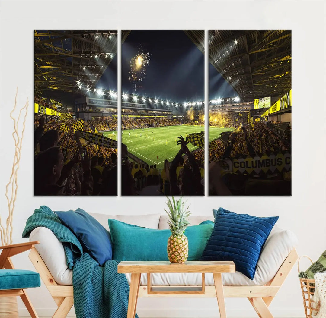 The wall of a modern living room is adorned with a triptych canvas titled "Columbus Crew Soccer Team Print," capturing the vibrant energy of the Columbus Crew Stadium in high-resolution printing.