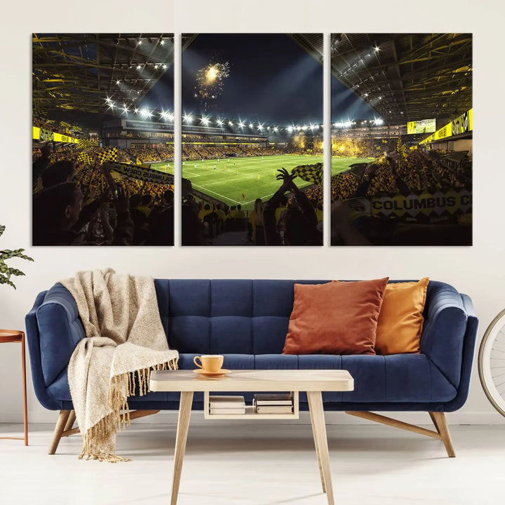 The wall of a modern living room is adorned with a triptych canvas titled "Columbus Crew Soccer Team Print," capturing the vibrant energy of the Columbus Crew Stadium in high-resolution printing.