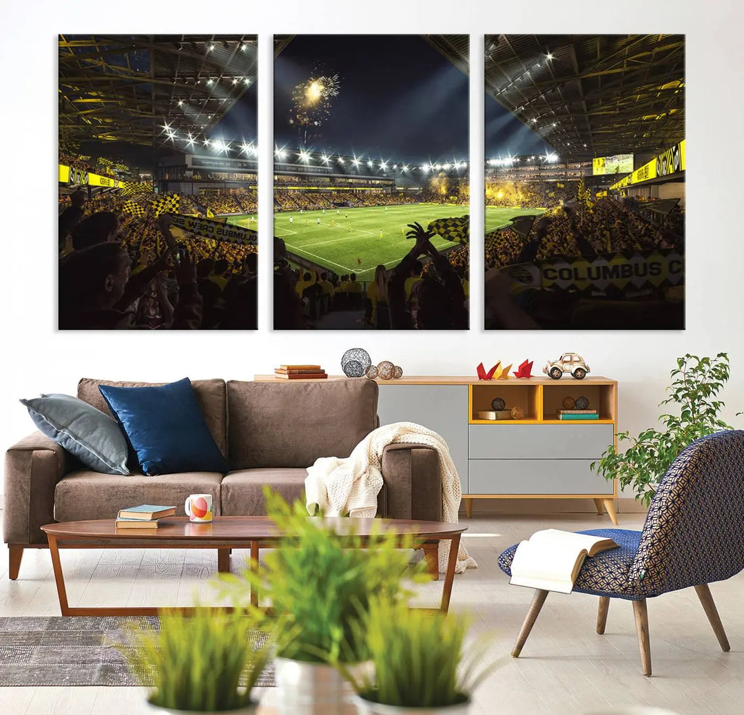 The wall of a modern living room is adorned with a triptych canvas titled "Columbus Crew Soccer Team Print," capturing the vibrant energy of the Columbus Crew Stadium in high-resolution printing.