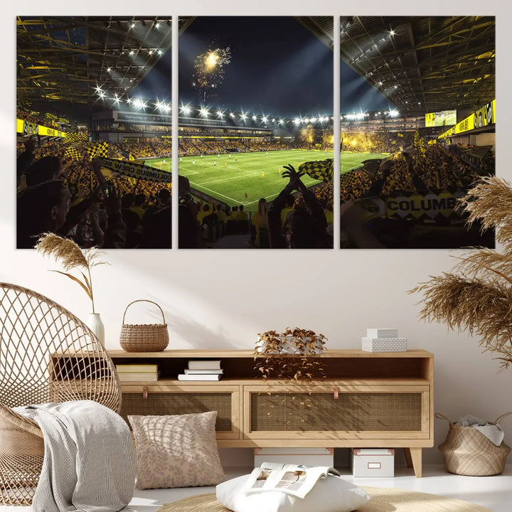 The wall of a modern living room is adorned with a triptych canvas titled "Columbus Crew Soccer Team Print," capturing the vibrant energy of the Columbus Crew Stadium in high-resolution printing.