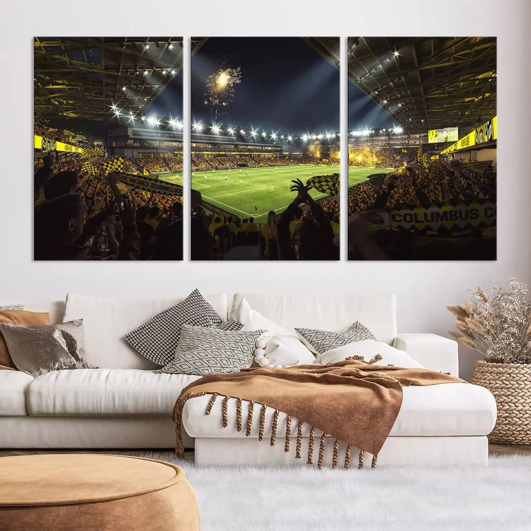 The wall of a modern living room is adorned with a triptych canvas titled "Columbus Crew Soccer Team Print," capturing the vibrant energy of the Columbus Crew Stadium in high-resolution printing.