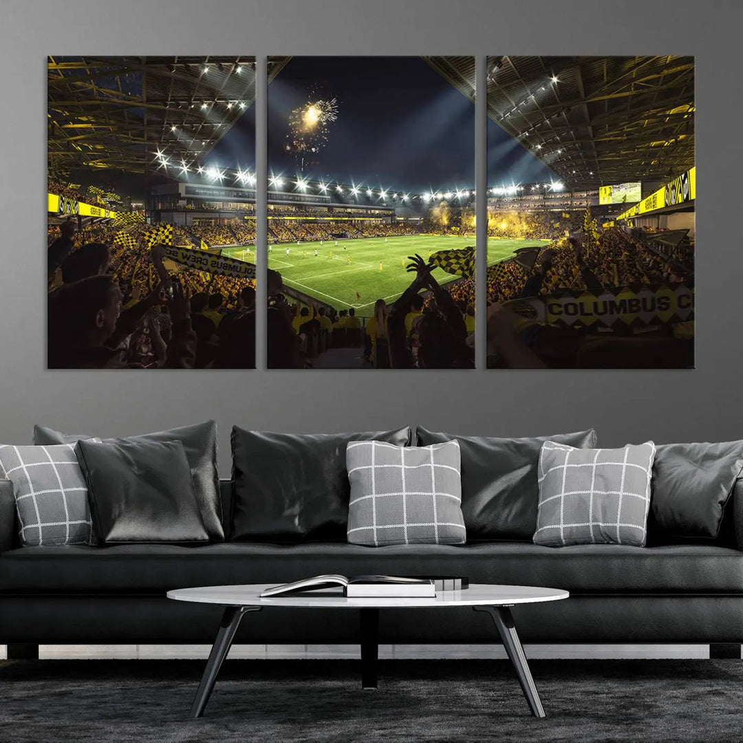 The wall of a modern living room is adorned with a triptych canvas titled "Columbus Crew Soccer Team Print," capturing the vibrant energy of the Columbus Crew Stadium in high-resolution printing.