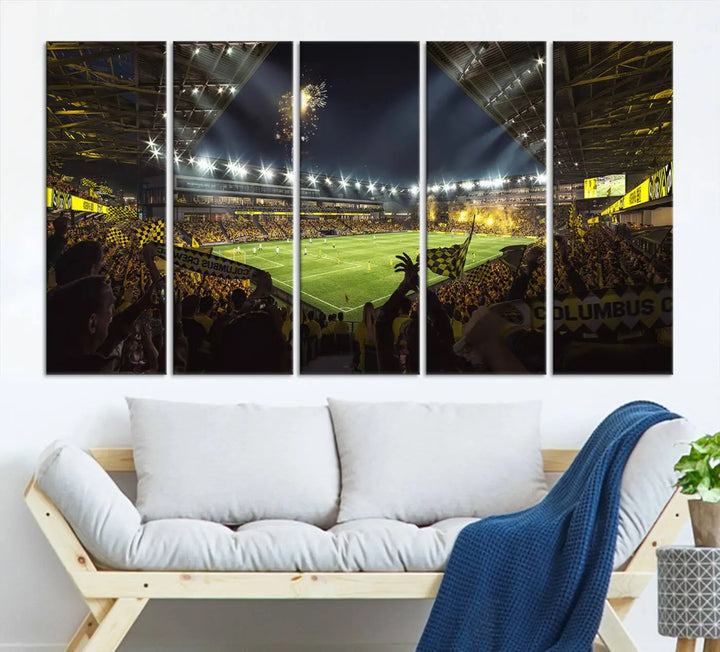 The wall of a modern living room is adorned with a triptych canvas titled "Columbus Crew Soccer Team Print," capturing the vibrant energy of the Columbus Crew Stadium in high-resolution printing.