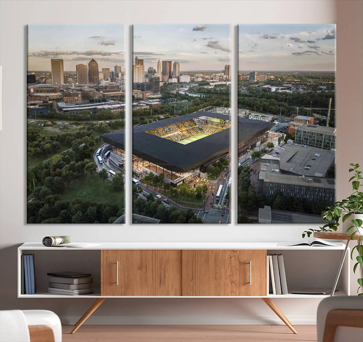 A living room is adorned with the Columbus Crew Soccer Team Print, showcasing a triptych of Columbus Crew Stadium and cityscape on museum-quality canvas. The high-resolution printing ensures vivid detail, while a UV-protective coating preserves its brilliance.