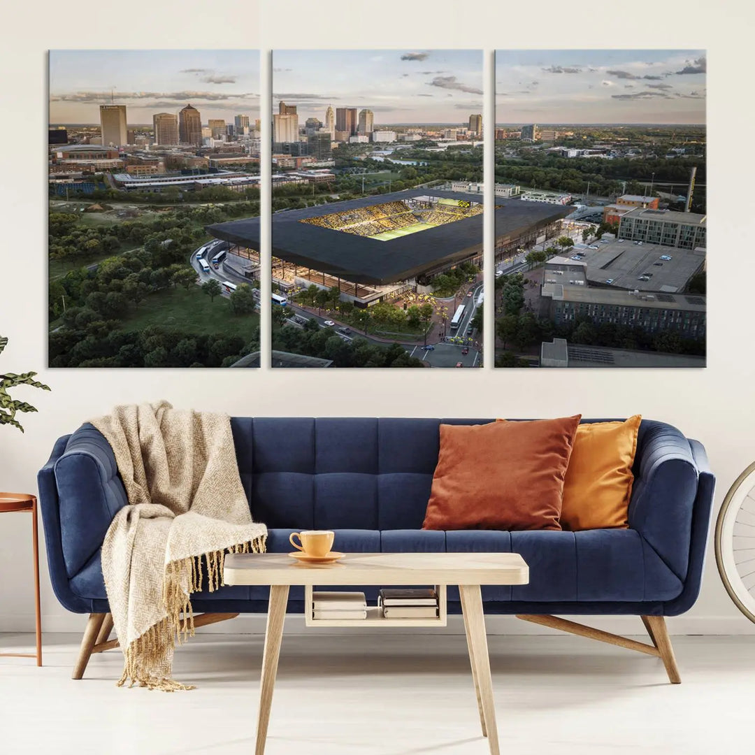 A living room is adorned with the Columbus Crew Soccer Team Print, showcasing a triptych of Columbus Crew Stadium and cityscape on museum-quality canvas. The high-resolution printing ensures vivid detail, while a UV-protective coating preserves its brilliance.