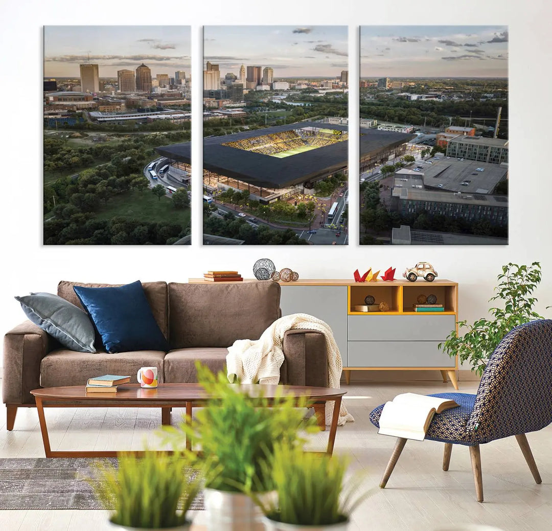 A living room is adorned with the Columbus Crew Soccer Team Print, showcasing a triptych of Columbus Crew Stadium and cityscape on museum-quality canvas. The high-resolution printing ensures vivid detail, while a UV-protective coating preserves its brilliance.